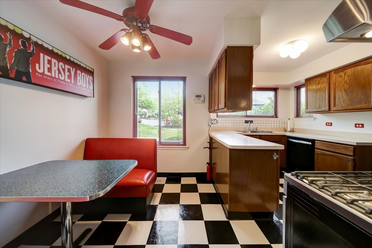 8325 High Point Circle, Unit A Darien, IL 60561 - Photo 8 of 42 a kitchen with a sink a stove a dining table and chairs