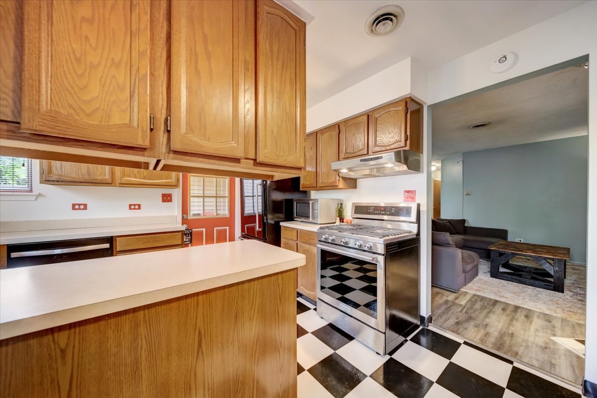 8325 High Point Circle, Unit A Darien, IL 60561 - Photo 10 of 42 a kitchen with stainless steel appliances a stove a sink and cabinets