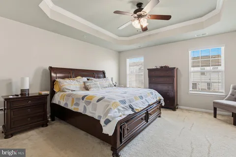a bedroom with a bed dresser and a window