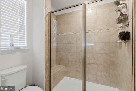 a bathroom with a shower and a toilet