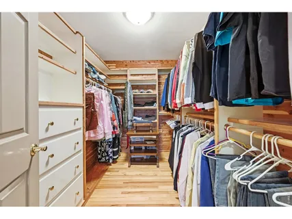 a view of walk in closet with clothes