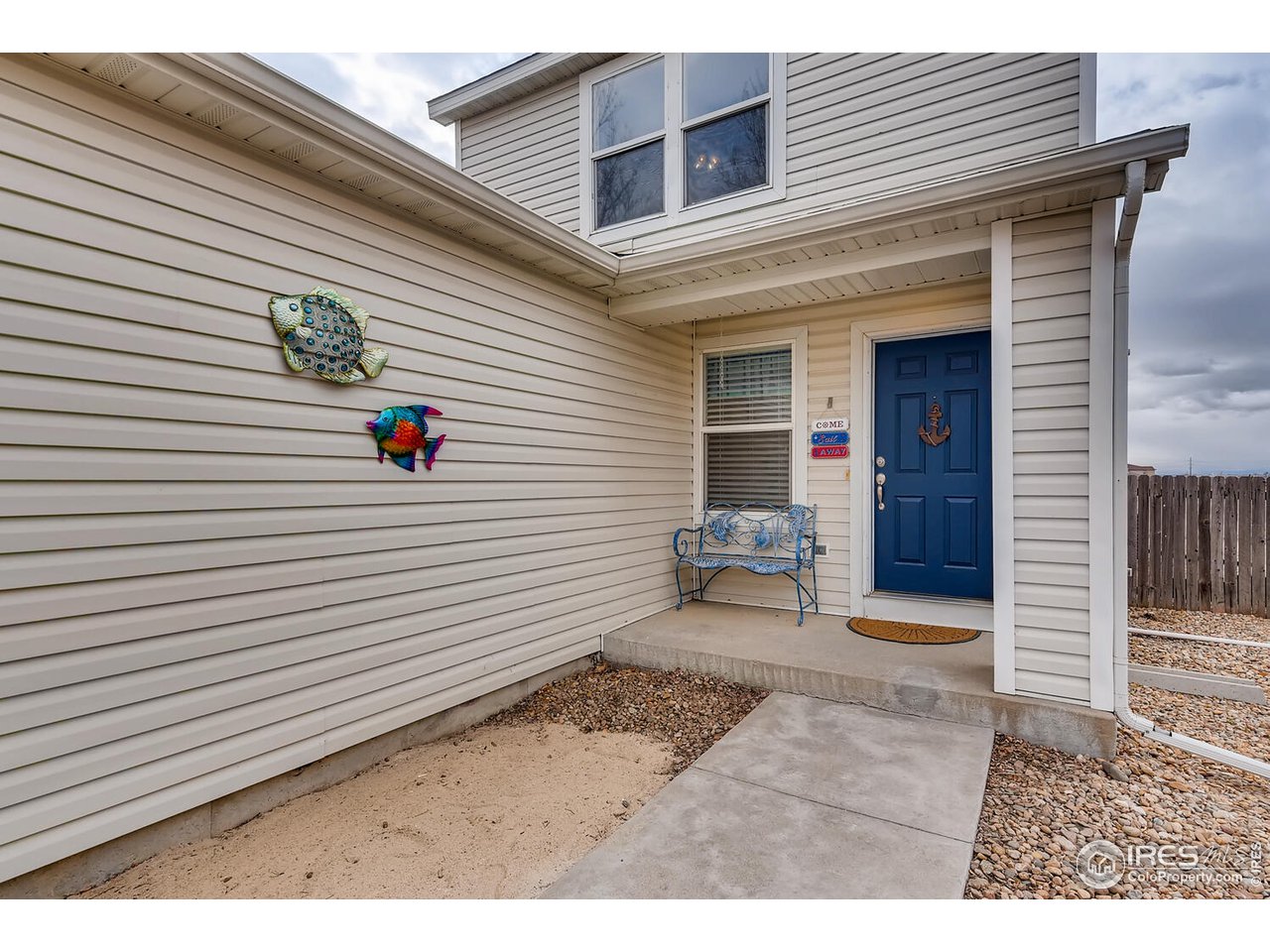 261 Ponderosa Place Fort Lupton, CO 80621 - Photo 2 of 15 a view of a house with a small backyard