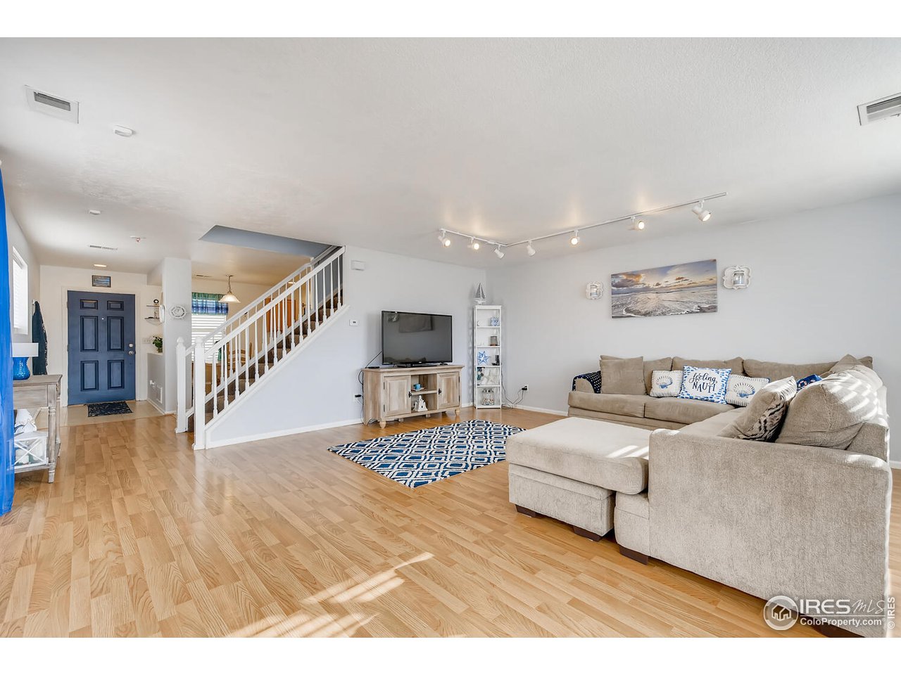 261 Ponderosa Place Fort Lupton, CO 80621 - Photo 15 of 15 a living room with furniture and a wooden floor