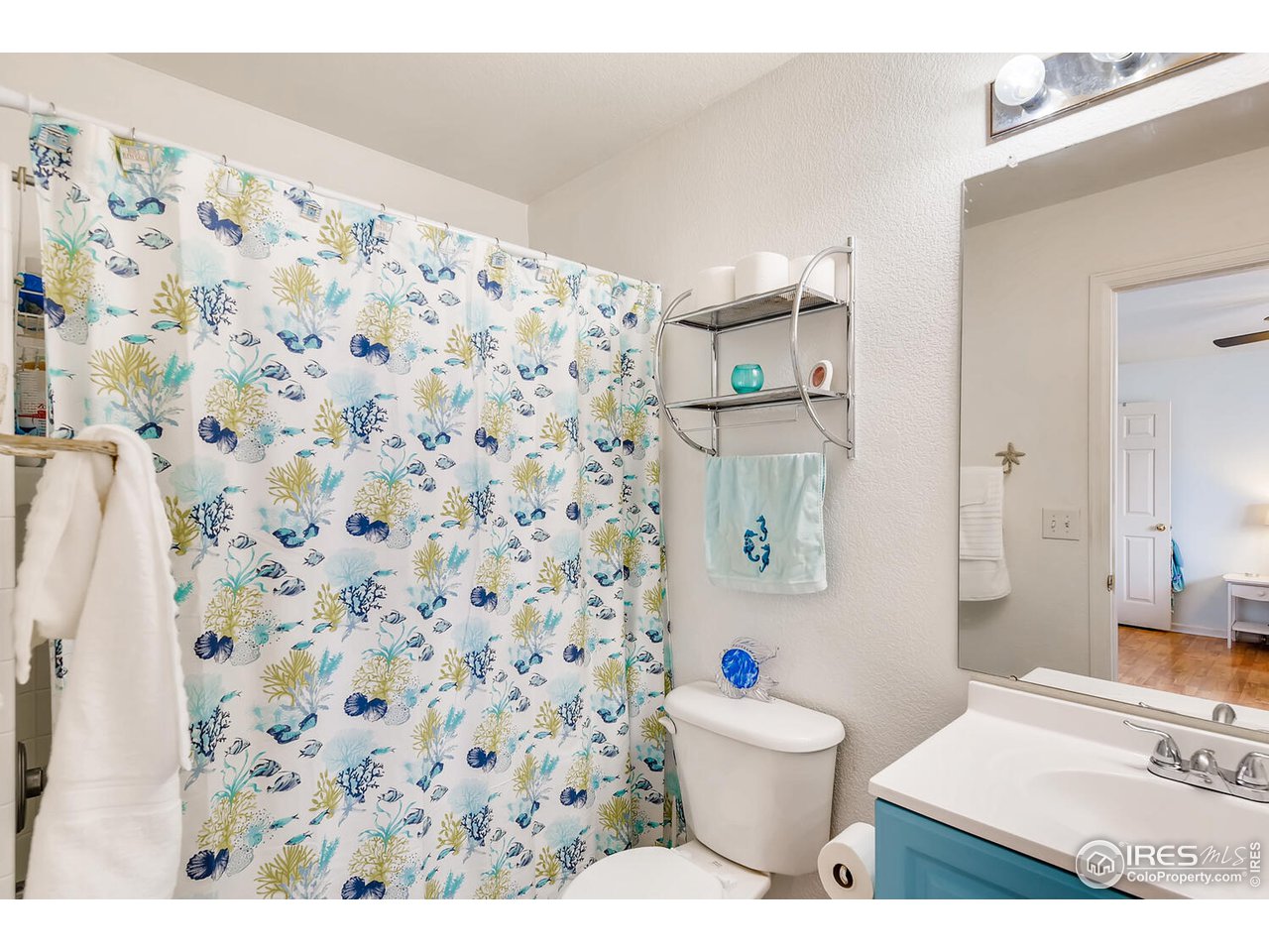 261 Ponderosa Place Fort Lupton, CO 80621 - Photo 8 of 15 a bathroom with a toilet and a shower curtain