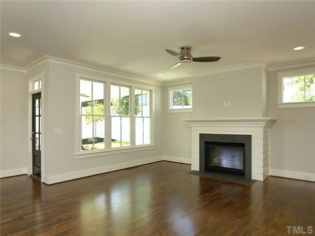 2004 Vinnings Place Raleigh, NC 27608 - Photo 4 of 22 an empty room with wooden floor fireplace and windows