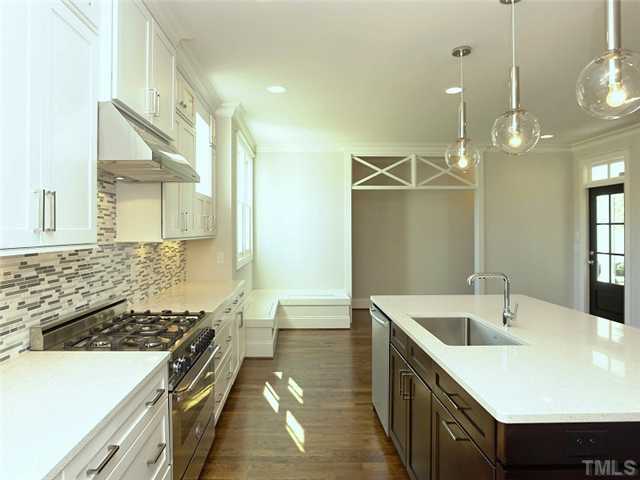 2004 Vinnings Place Raleigh, NC 27608 - Photo 8 of 22 a kitchen with a sink stove and cabinets