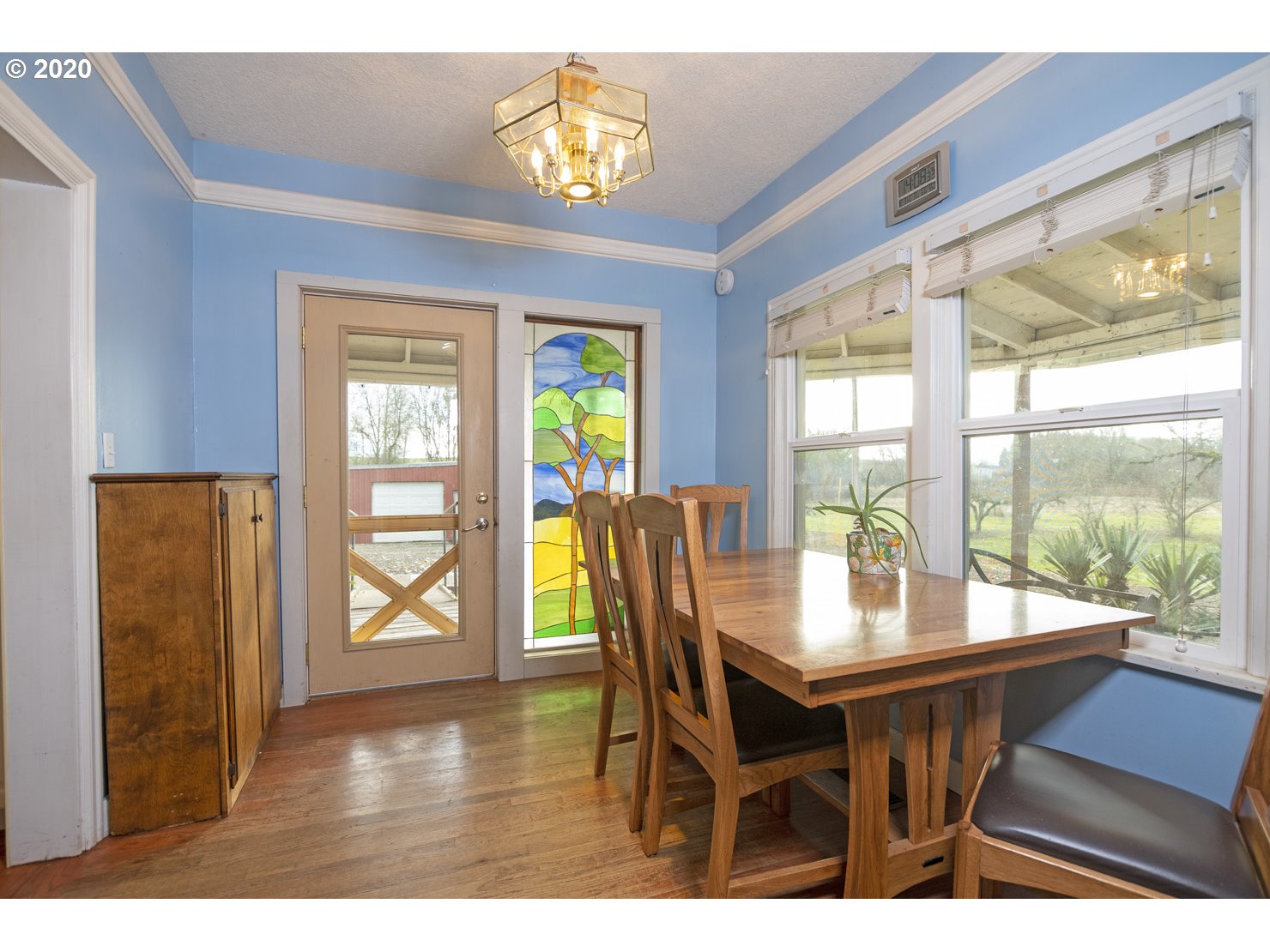 41300 Southwest Laurelwood Road Gaston, OR 97119 - Photo 11 of 29 a dining room with furniture a chandelier and wooden floor