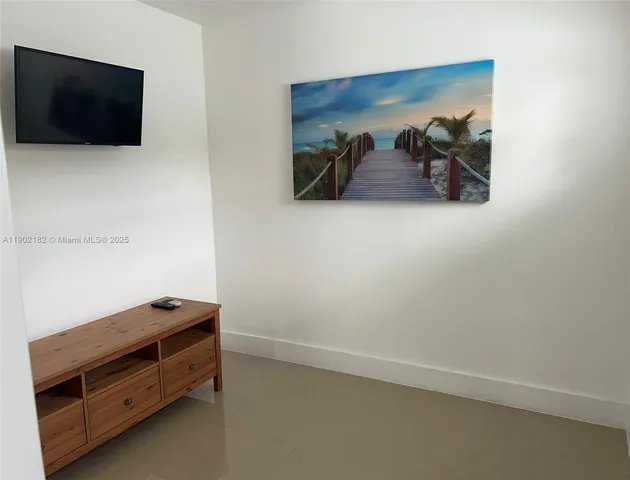 a room with a bed and a flat screen tv