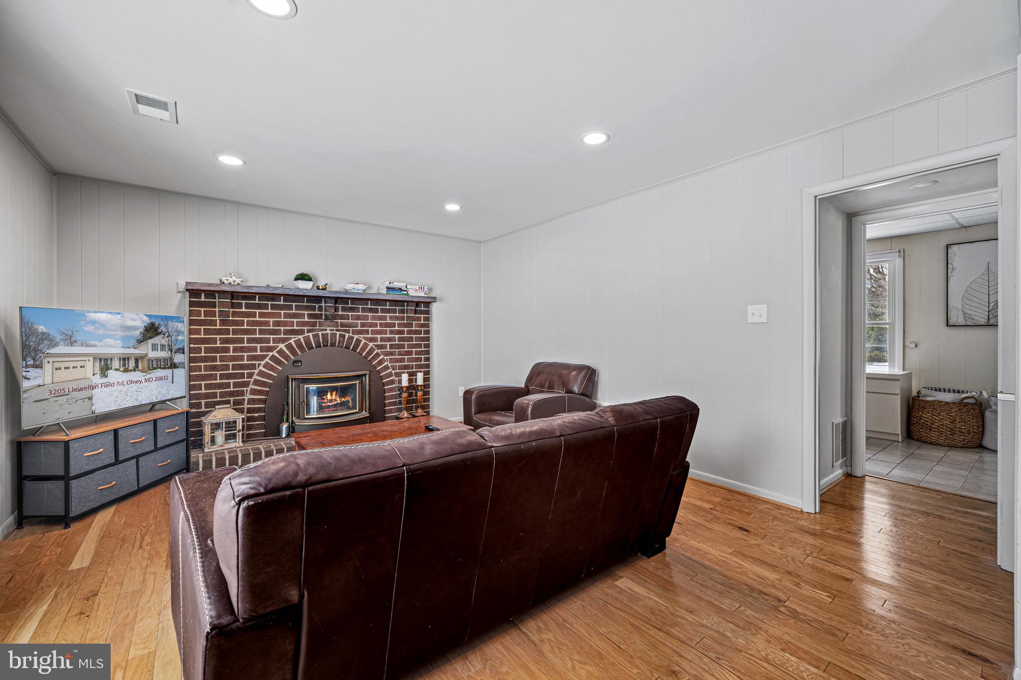 3205 Llewellyn Field Road Olney, MD 20832 - Photo 12 of 39 a living room with furniture and a fireplace