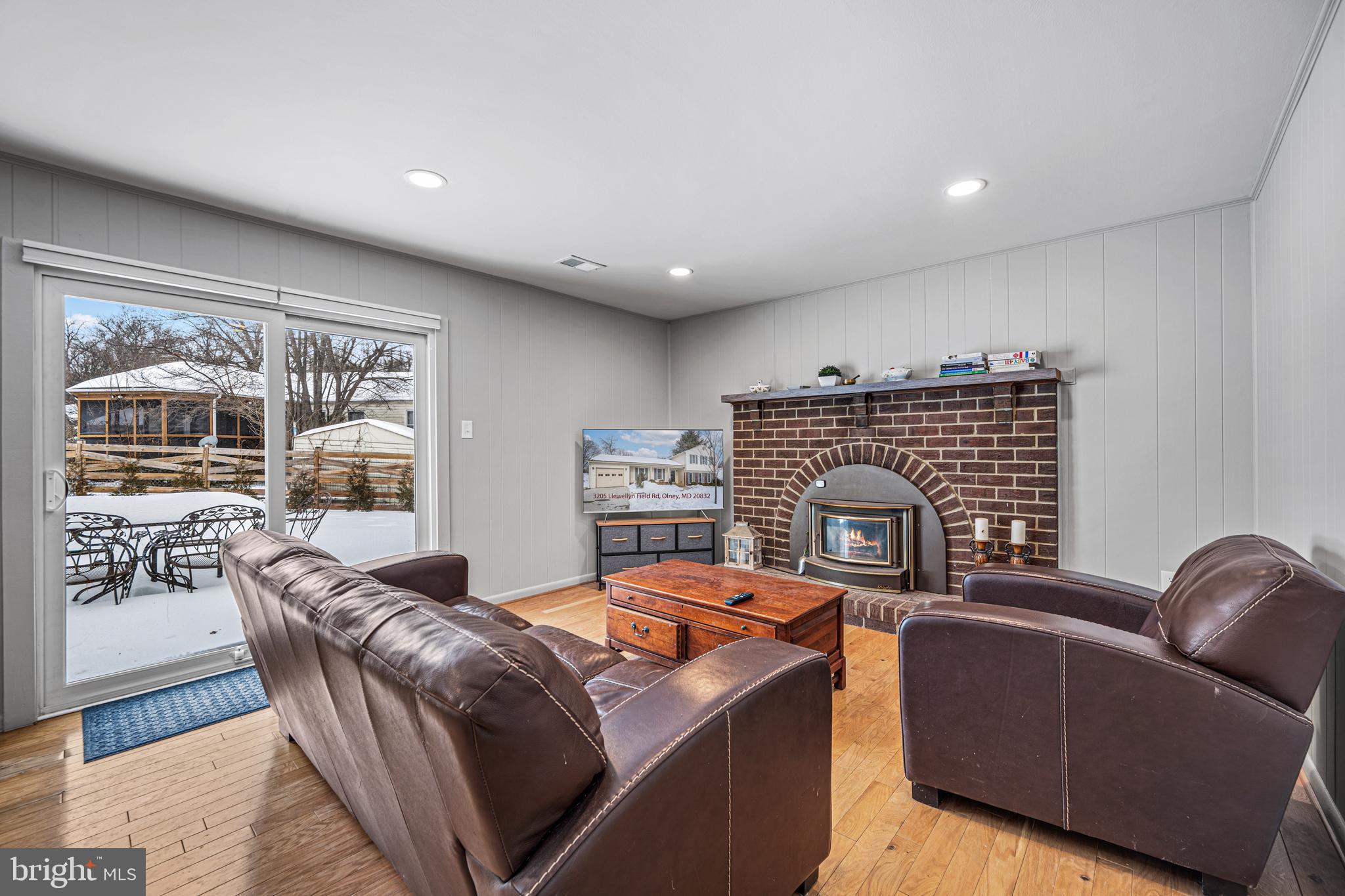 3205 Llewellyn Field Road Olney, MD 20832 - Photo 14 of 39 a living room with furniture a fireplace and wooden floor