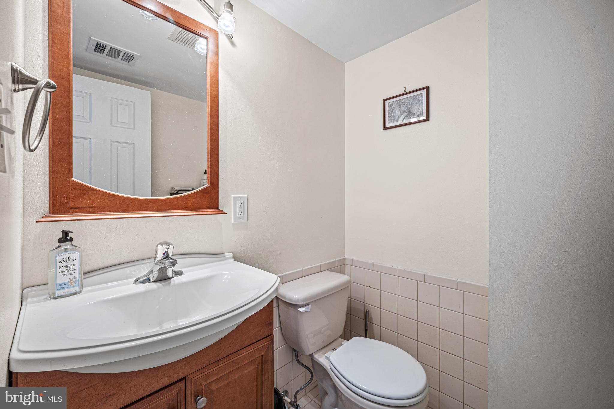 3205 Llewellyn Field Road Olney, MD 20832 - Photo 16 of 39 a bathroom with a sink a toilet and mirror