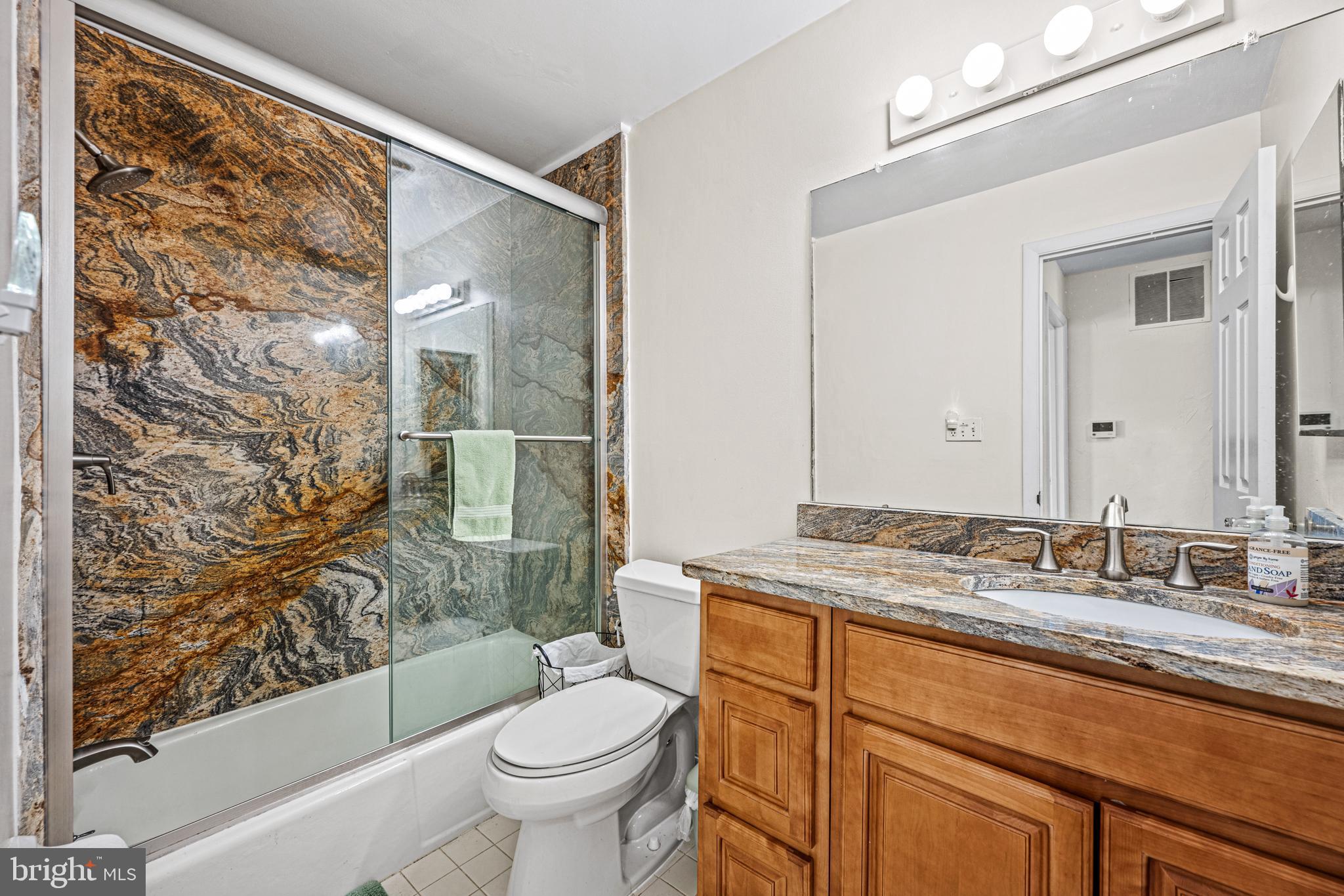 3205 Llewellyn Field Road Olney, MD 20832 - Photo 22 of 39 a bathroom with a granite countertop sink toilet and shower