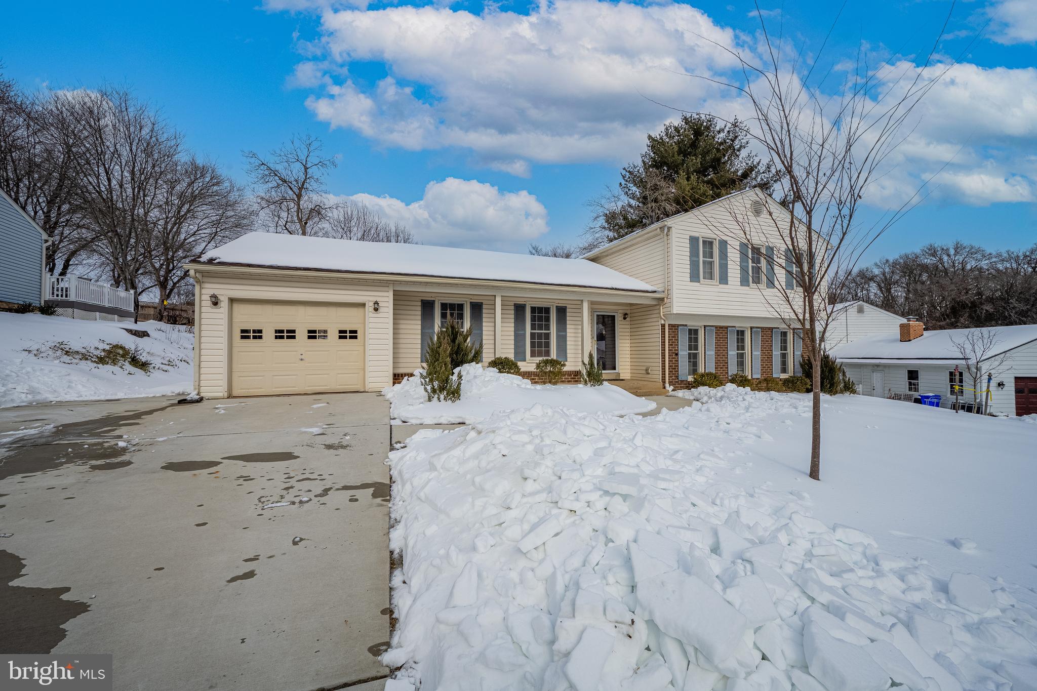3205 Llewellyn Field Road Olney, MD 20832 - Photo 29 of 39 a view of a white house with a yard covered in snow