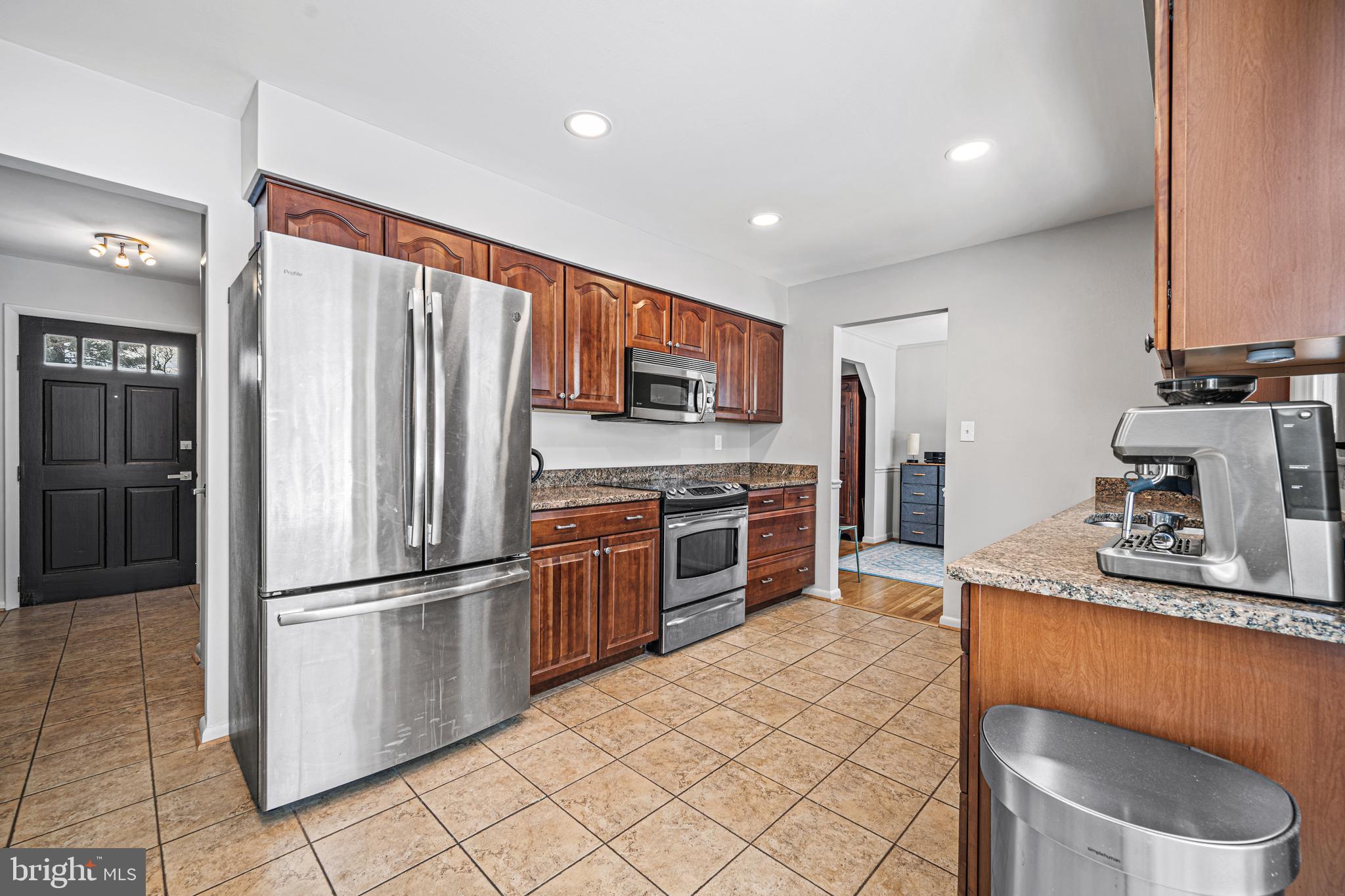 3205 Llewellyn Field Road Olney, MD 20832 - Photo 8 of 39 a kitchen with stainless steel appliances a refrigerator and a stove top oven