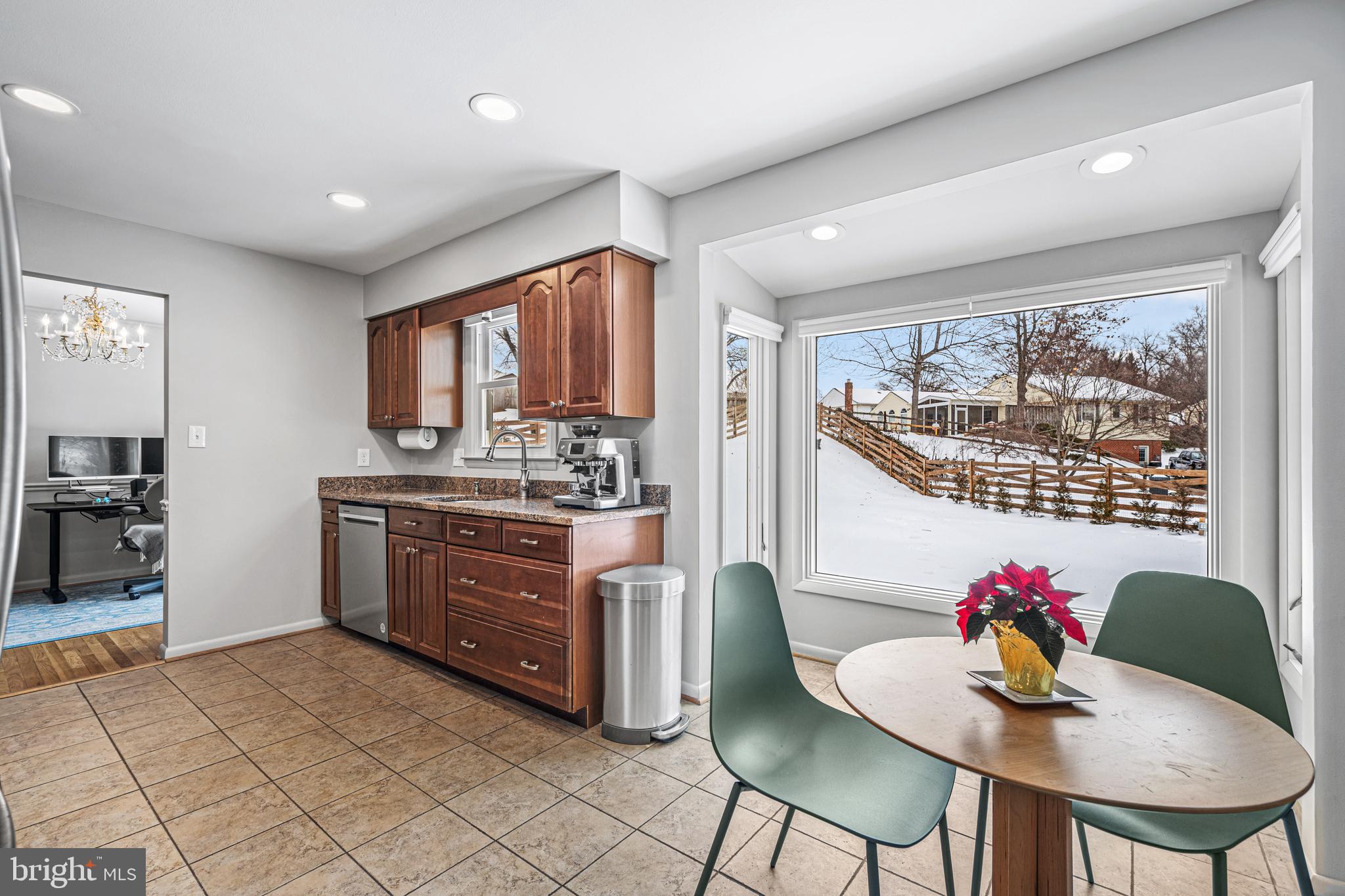 3205 Llewellyn Field Road Olney, MD 20832 - Photo 10 of 39 a kitchen with stainless steel appliances kitchen island granite countertop a refrigerator a stove a sink dishwasher with a dining table and chair