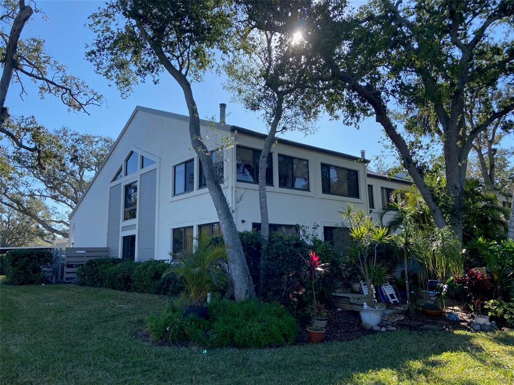 11450 Harbor Way, Unit 5002 Largo, FL 33774 - Photo 18 of 25 a front view of a house with a garden