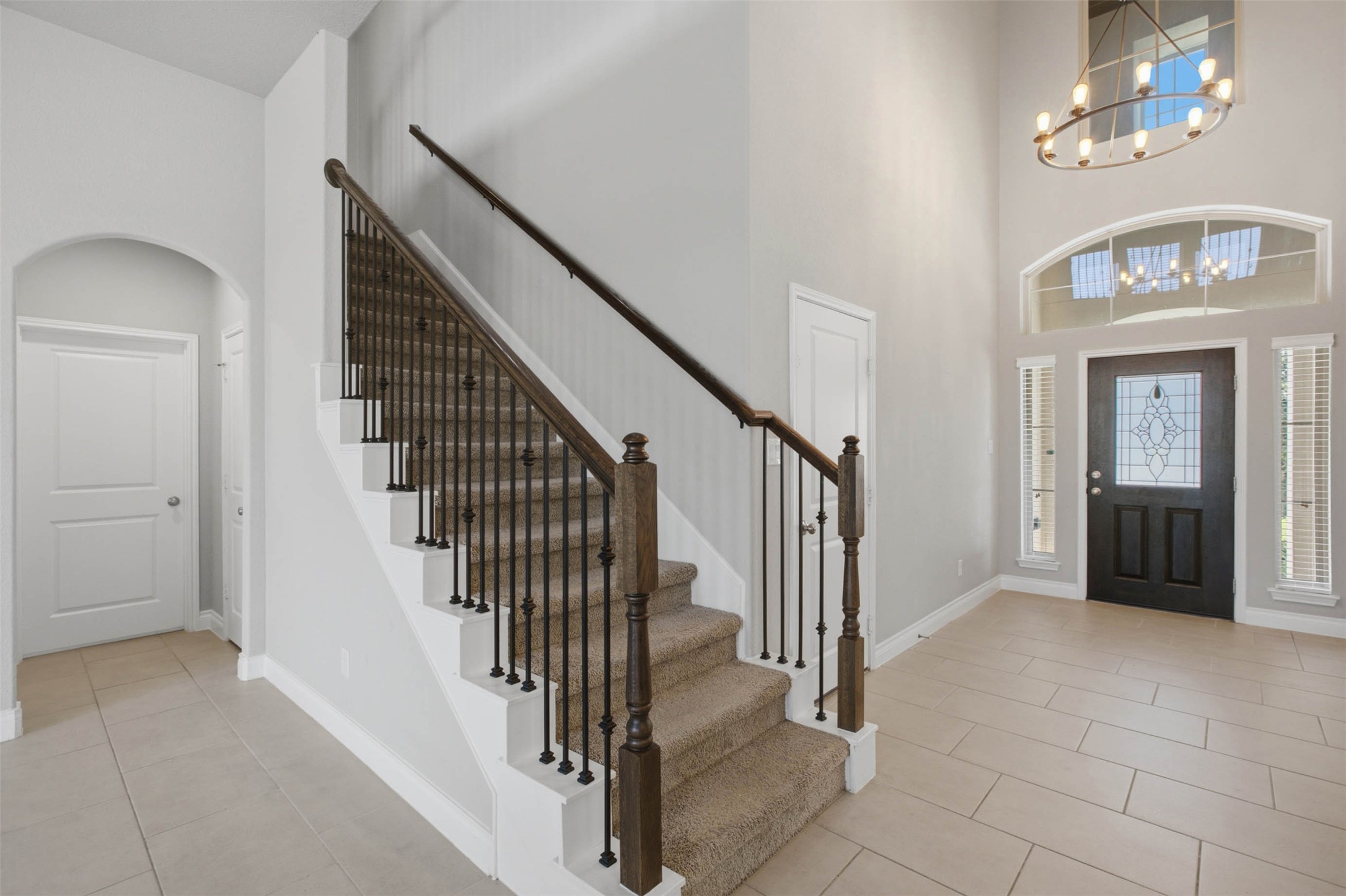 3101 Rabbit Creek Drive Georgetown, TX 78626 - Photo 12 of 38 A grand entryway welcomes with a sweeping staircase and an ornate glass-paneled door.