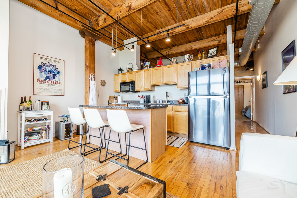 1250 West Van Buren Street, Unit 703 Chicago, IL 60607 - Photo 16 of 18 a kitchen with stainless steel appliances a refrigerator and wooden floor