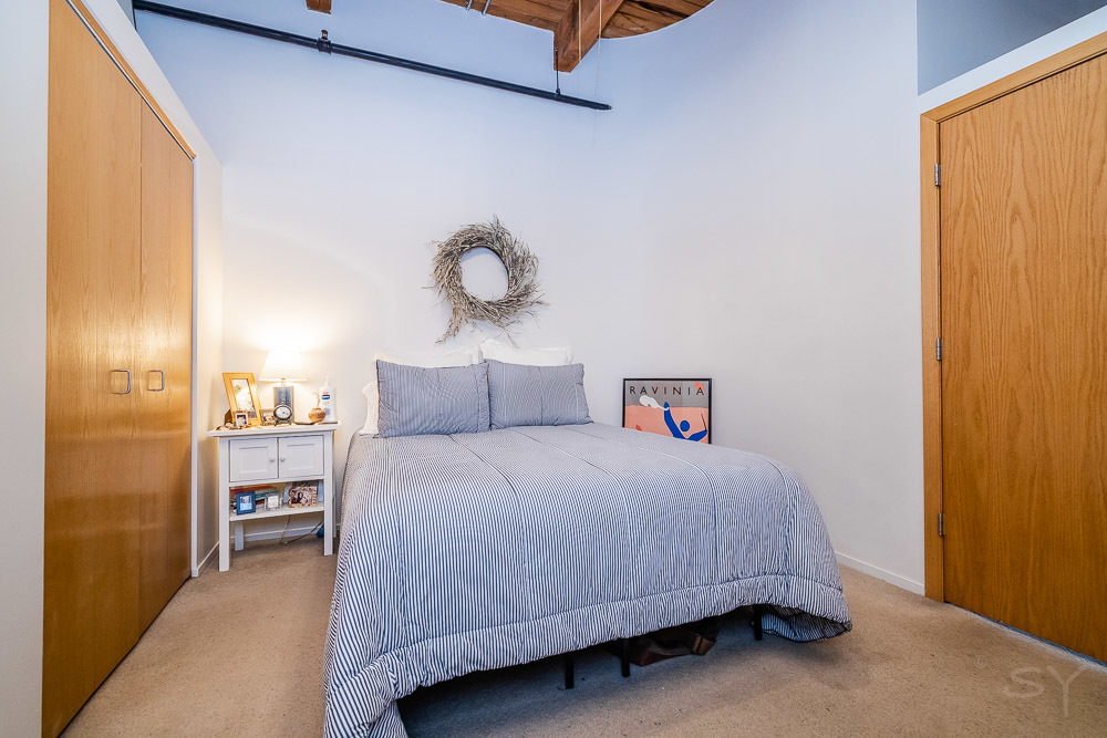 1250 West Van Buren Street, Unit 703 Chicago, IL 60607 - Photo 4 of 18 a bedroom with a bed and a window