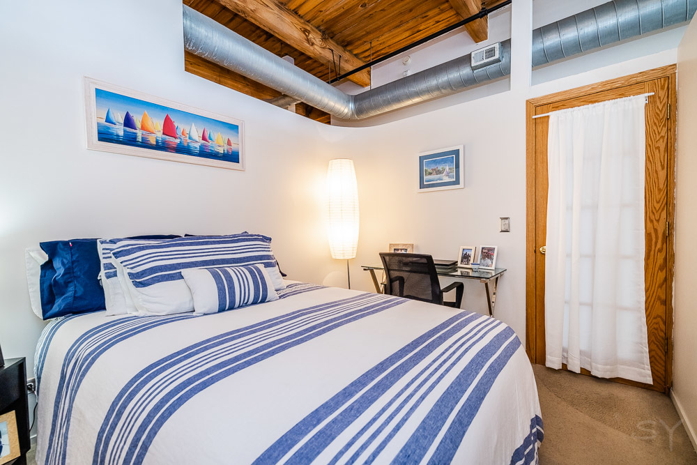 1250 West Van Buren Street, Unit 703 Chicago, IL 60607 - Photo 7 of 18 a bedroom with bed and a window
