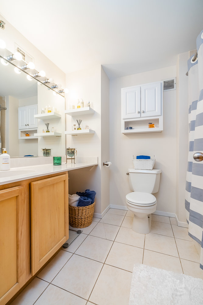 1250 West Van Buren Street, Unit 703 Chicago, IL 60607 - Photo 8 of 18 a bathroom with a toilet sink and mirror
