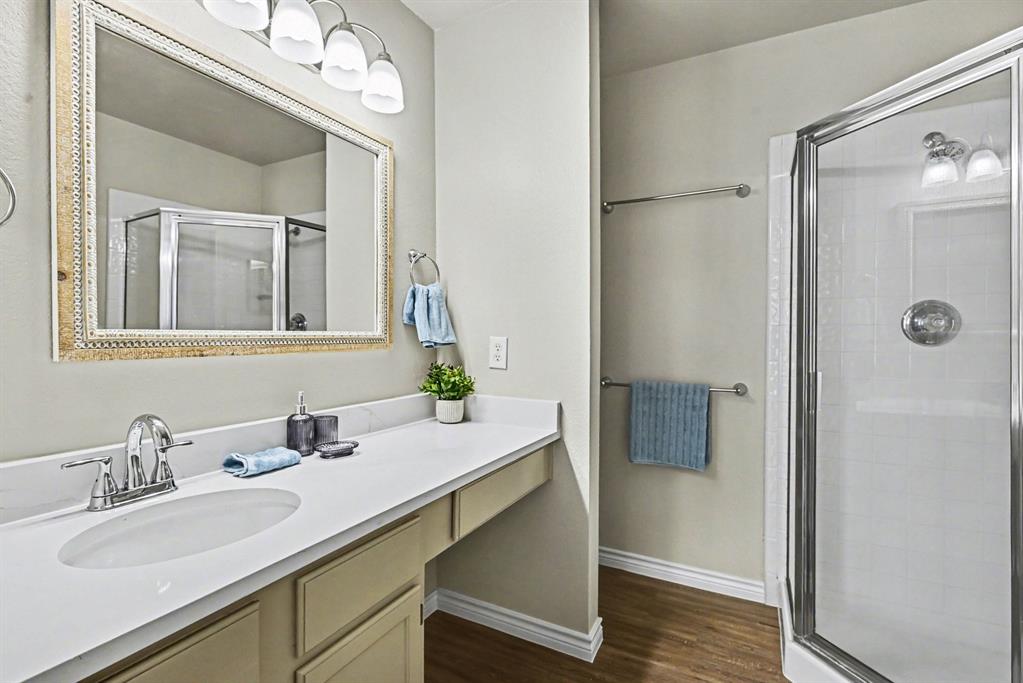 6113 Haley Lane Fort Worth, TX 76132 - Photo 21 of 38 Primary Bedroom ensuite bathroom. Walk-in shower, cabinets, linen closet, new plumbing fixtures, new light fixtures and new toilet.