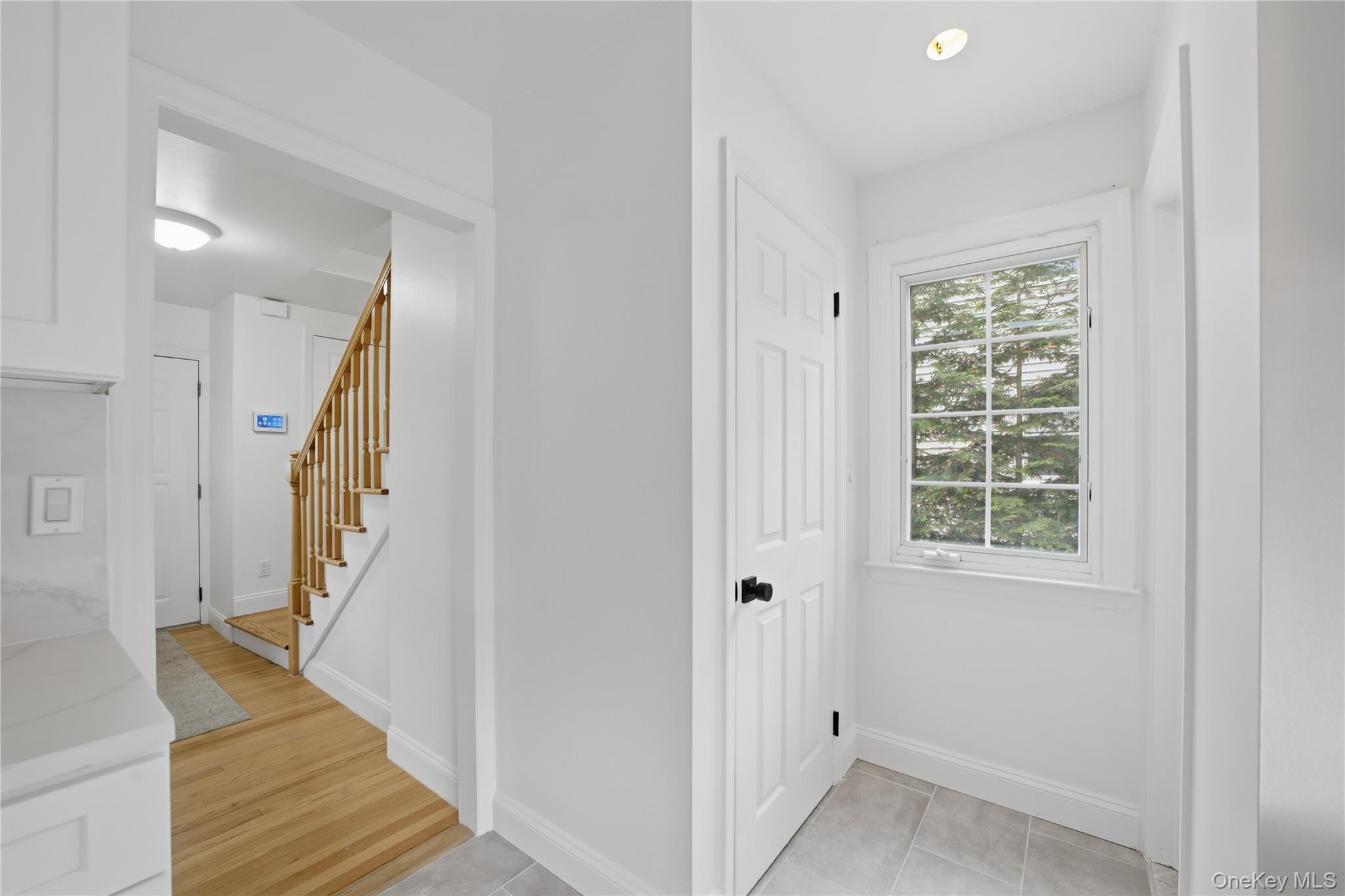 144 Bell Road Scarsdale, NY 10583 - Photo 18 of 49 Half bath off kitchen with exit onto deck. Entry hallway to the stairs leading up to the second floor