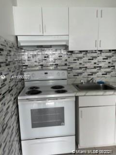 3640 Northwest 9th Street, Unit 105 Miami, FL 33125 - Photo 8 of 8 a stove top oven sitting inside of a kitchen