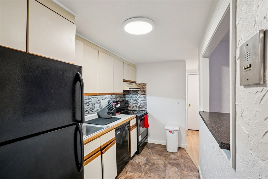 208 Swanson Road, Unit 526 Boxborough, MA 01719 - Photo 6 of 18 a kitchen with stainless steel appliances granite countertop a refrigerator and a stove