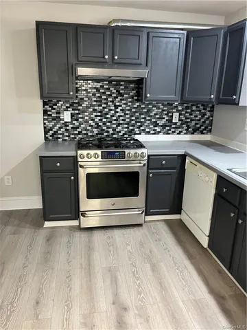 a kitchen with stainless steel appliances a stove a microwave and sink