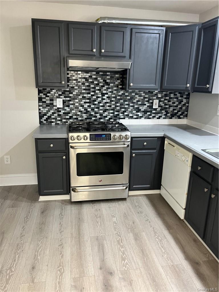 598 Highway 303 Blauvelt, NY 10913 - Photo 3 of 9 a kitchen with stainless steel appliances a stove a microwave and sink