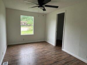 44 Balladeer Corinth, TX 76210 - Photo 11 of 15 an empty room with wooden floor fan and windows