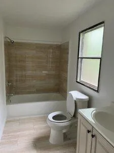 a bathroom with a toilet a sink and bathtub