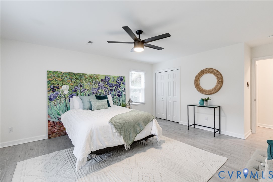10008 Brittonwood Drive North Chesterfield, VA 23237 - Photo 13 of 34 a bedroom with a bed a window and a chandelier