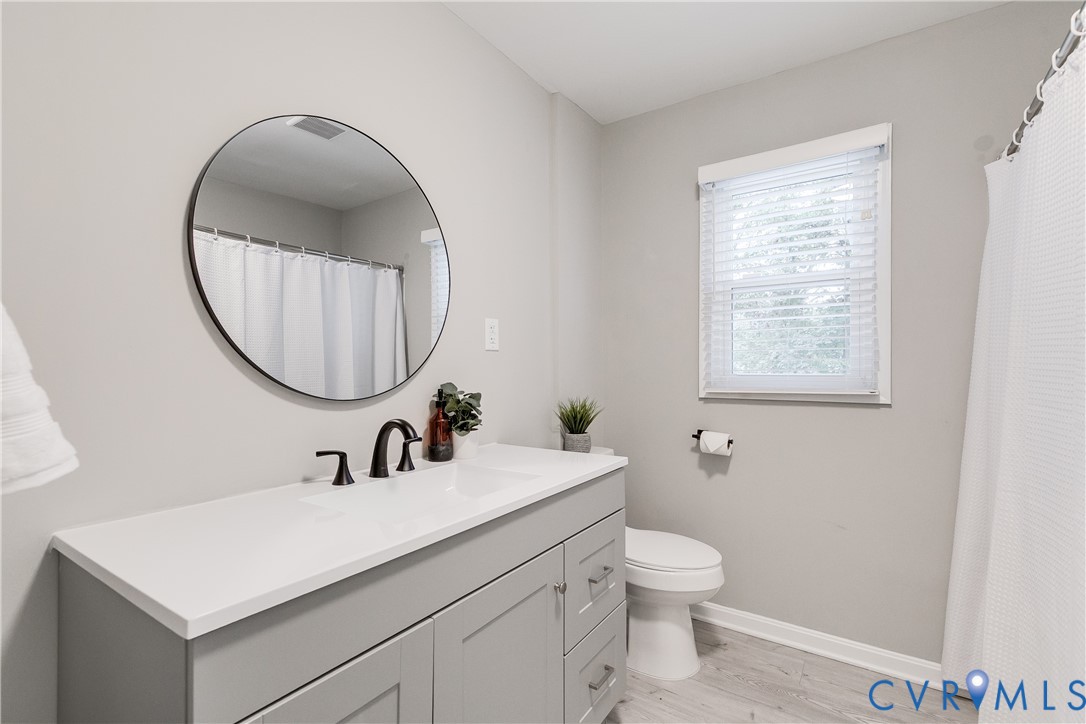 10008 Brittonwood Drive North Chesterfield, VA 23237 - Photo 20 of 34 a bathroom with a toilet a sink and a mirror