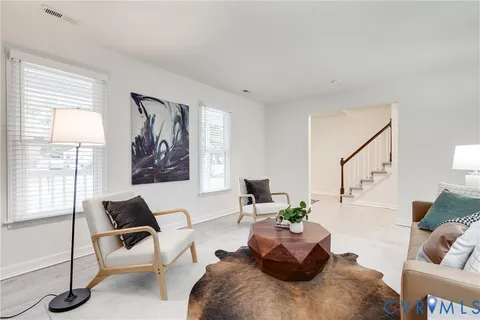 a kitchen with stainless steel appliances granite countertop a refrigerator a stove a sink a dining table and chairs