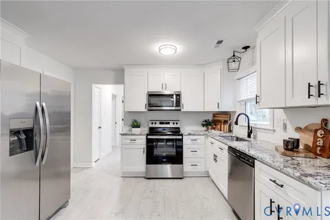 a bedroom with a bed a window and a chandelier