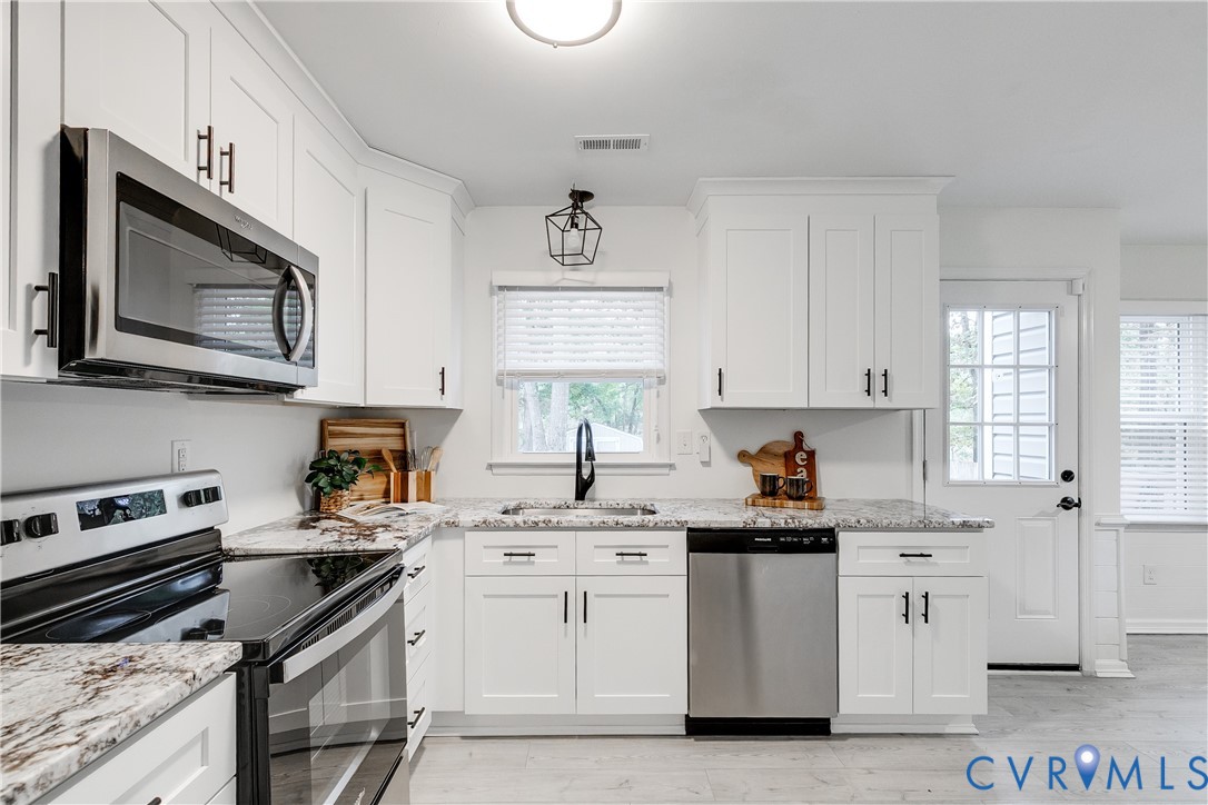 10008 Brittonwood Drive North Chesterfield, VA 23237 - Photo 7 of 34 a kitchen with white cabinets stainless steel appliances and sink