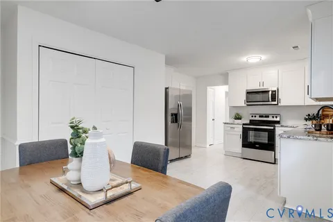 a backyard of a house with barbeque oven table and chairs