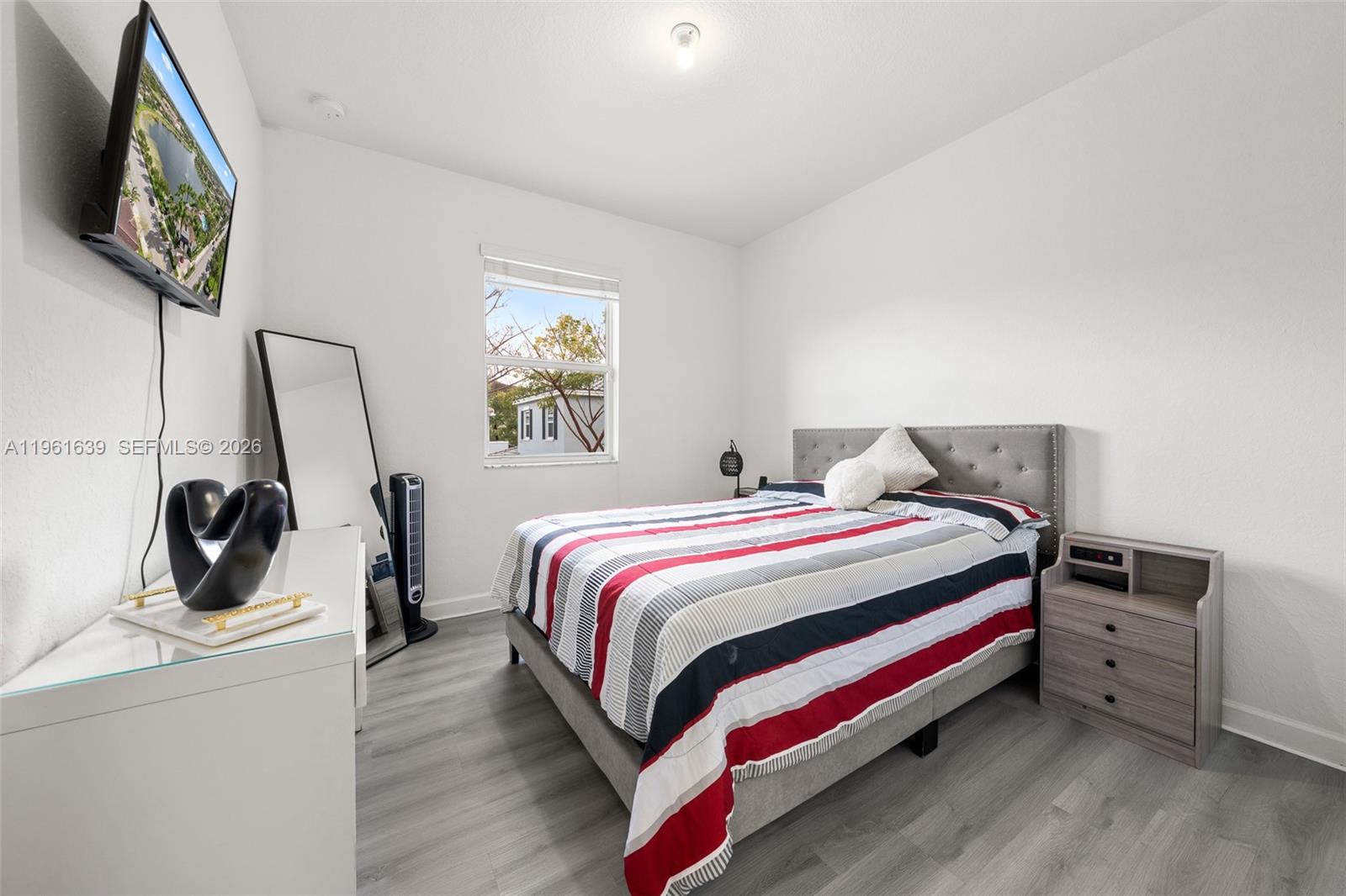 16958 Southwest 92nd Street, Unit 16958 Miami, FL 33196 - Photo 13 of 40 a bedroom with a bed and a flat screen tv