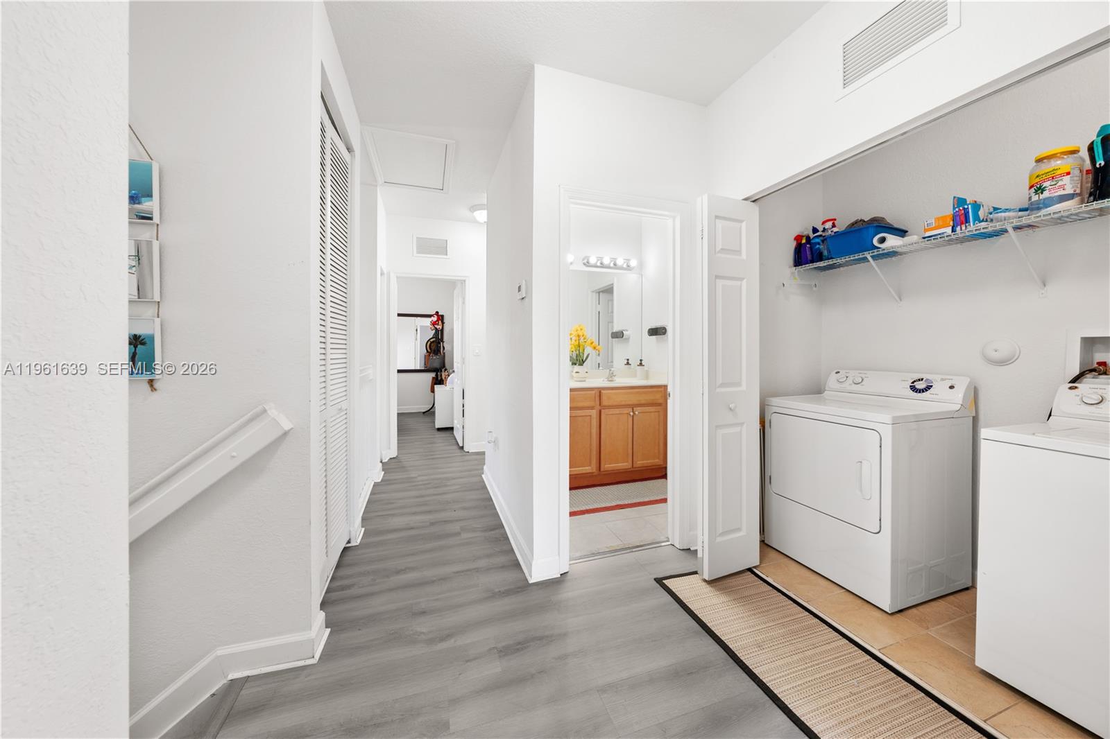 16958 Southwest 92nd Street, Unit 16958 Miami, FL 33196 - Photo 21 of 40 a view of a hallway with washer and dryer