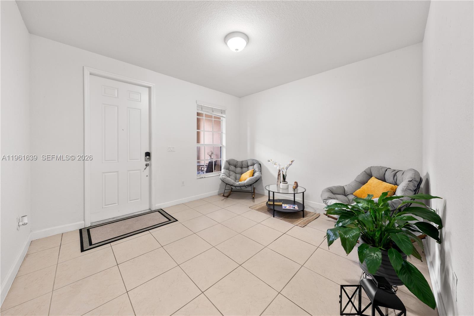 16958 Southwest 92nd Street, Unit 16958 Miami, FL 33196 - Photo 4 of 40 a room with white wall and has a potted plant on it