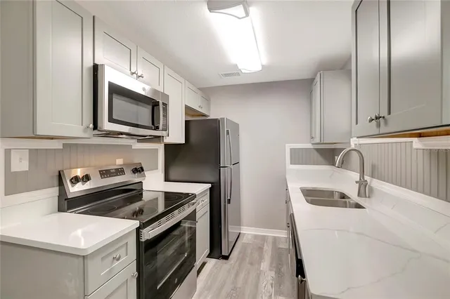 a kitchen with a sink stove and refrigerator