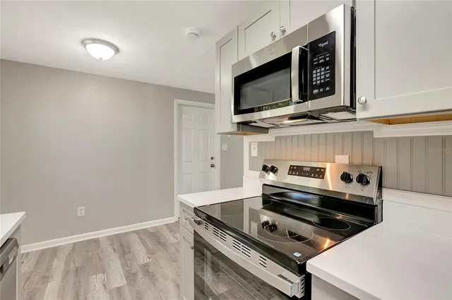 a kitchen with a stove and a microwave