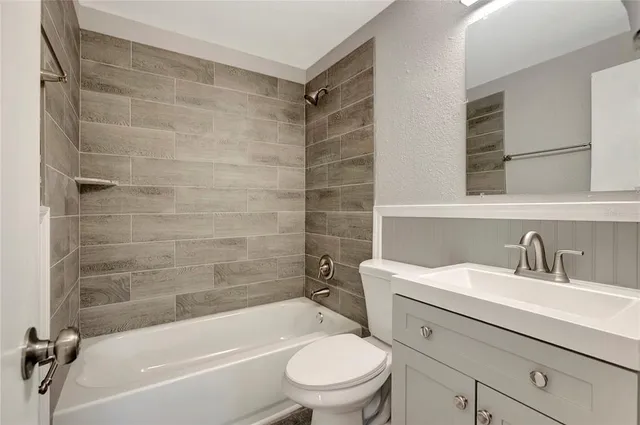 a bathroom with a sink a toilet and a bathtub