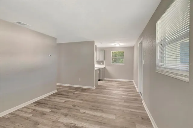 a view of wooden floor and windows in an empty room