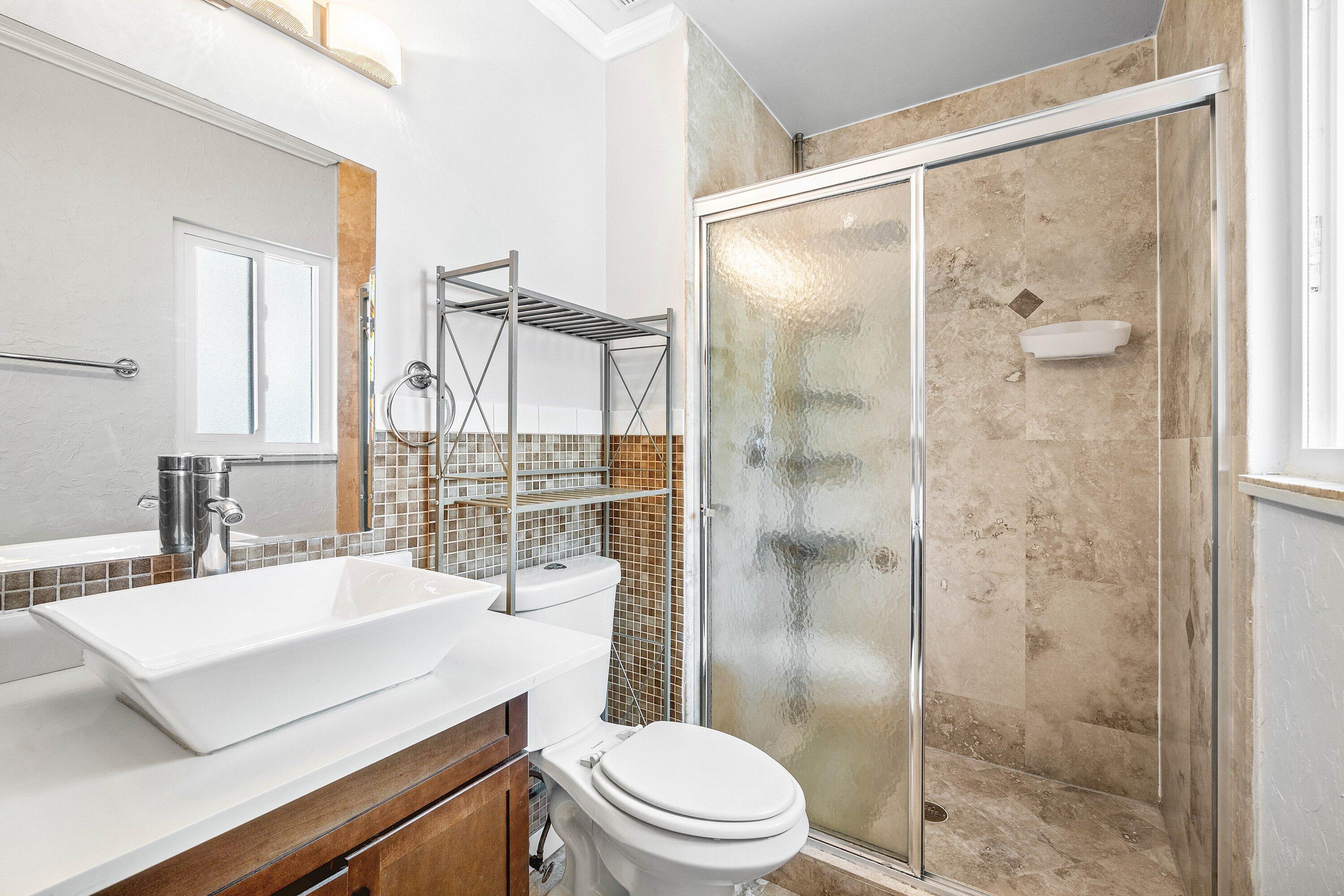 8411 Garden Gate Place Boca Raton, FL 33433 - Photo 6 of 12 a bathroom with a sink a toilet and shower