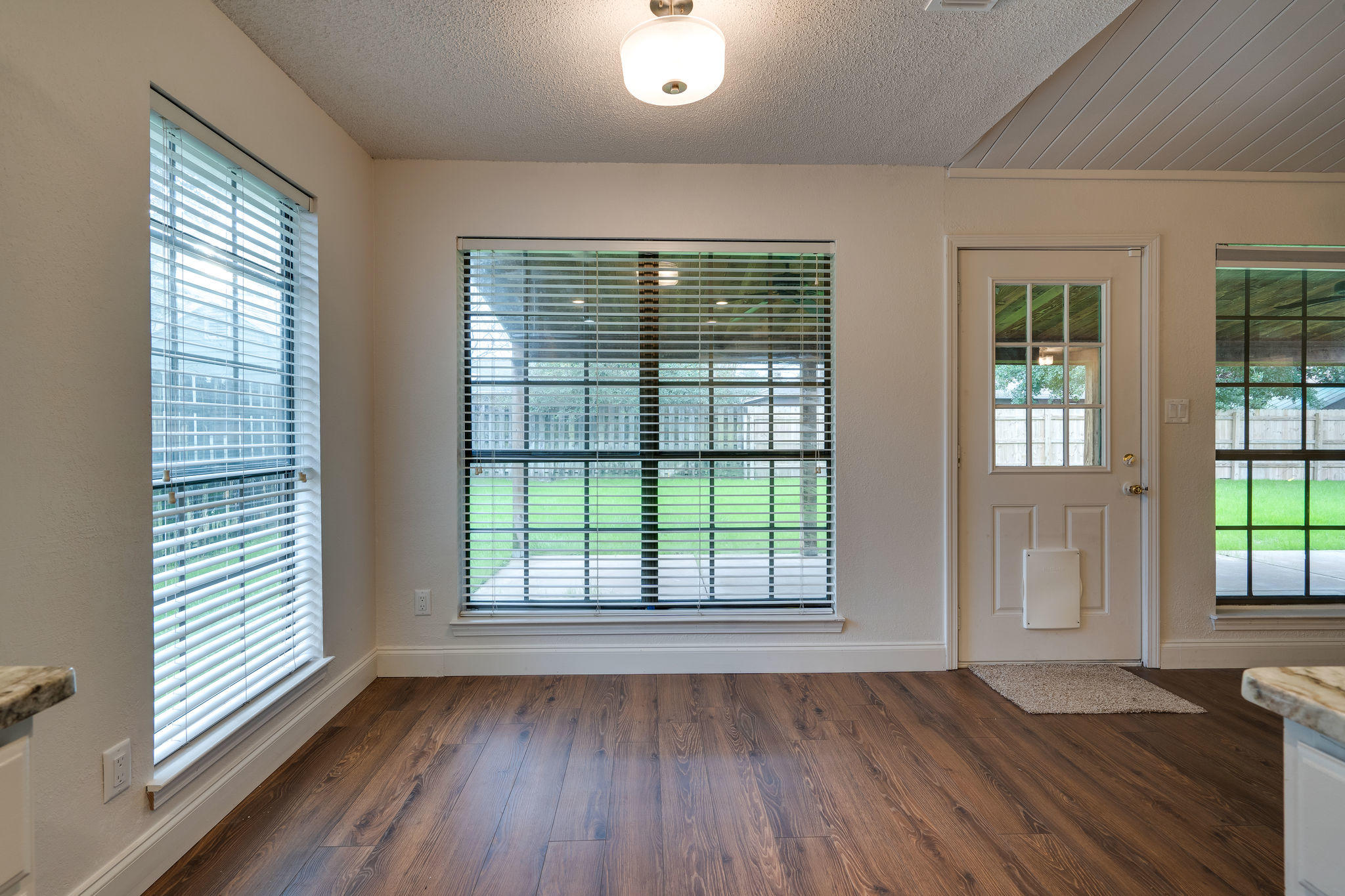 409 Juniper Street Destin, FL 32541 - Photo 14 of 32 an empty room with wooden floor and windows