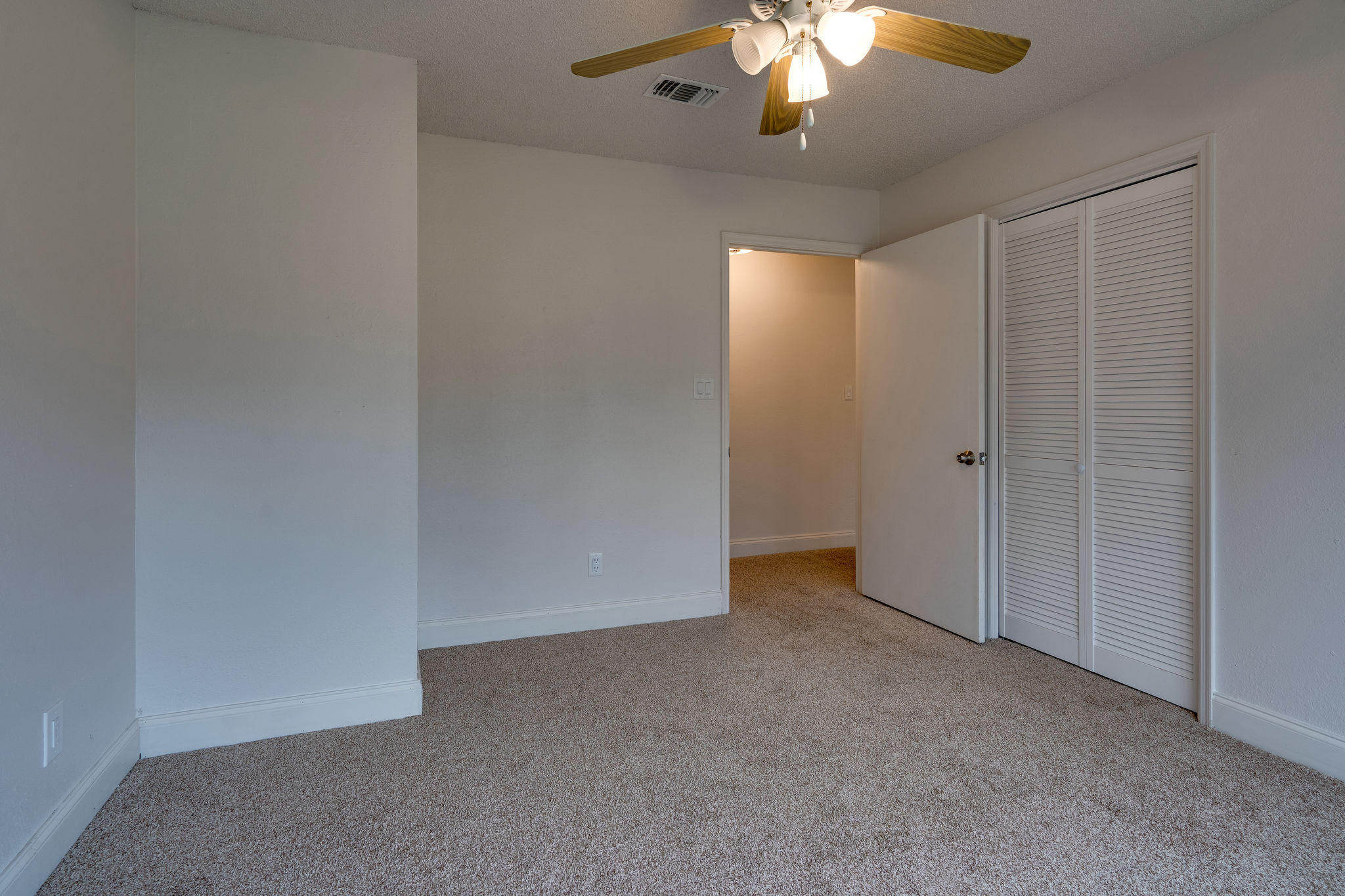 409 Juniper Street Destin, FL 32541 - Photo 19 of 32 an empty room with a chandelier fan