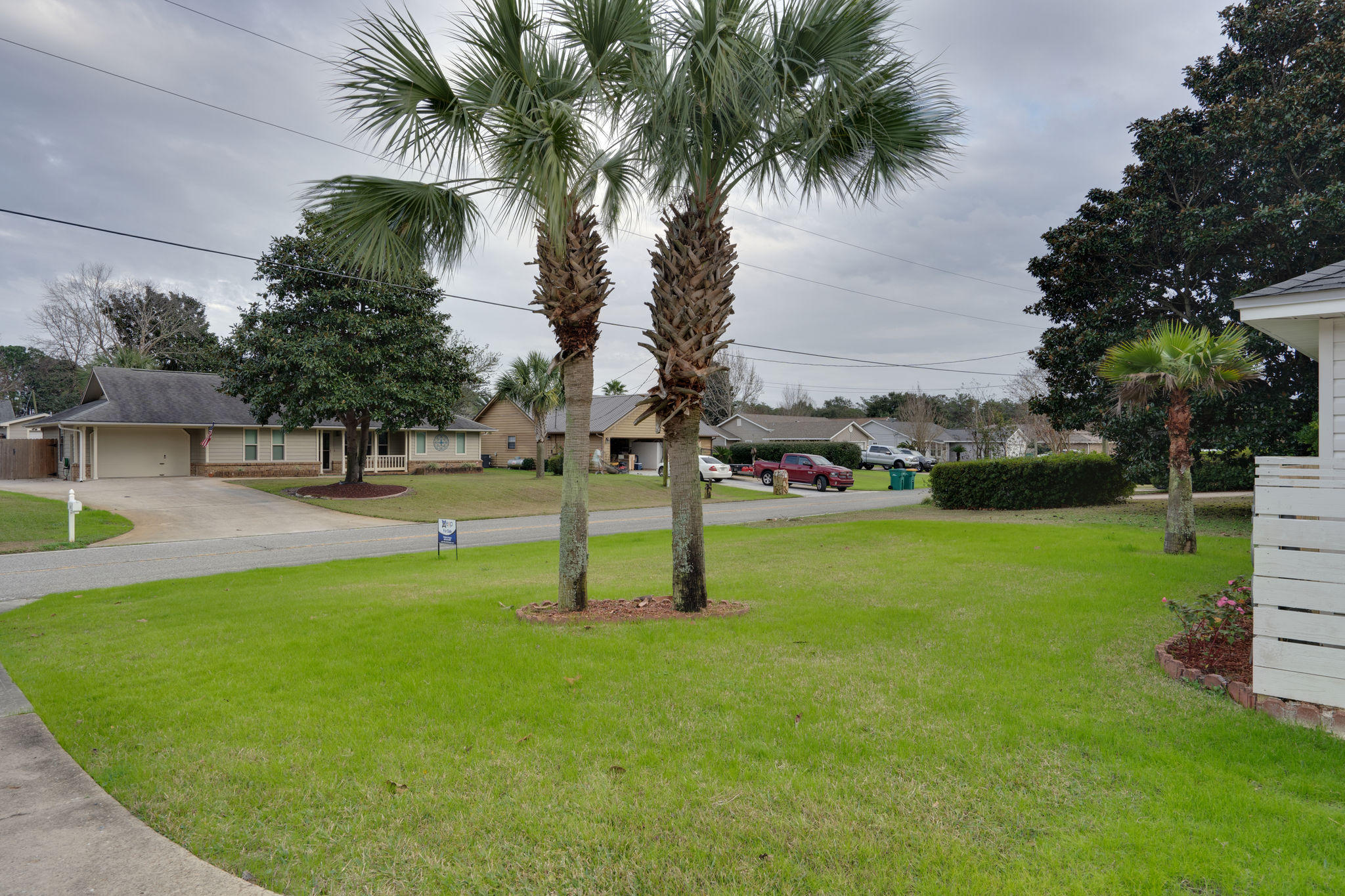409 Juniper Street Destin, FL 32541 - Photo 2 of 32 a swimming pool with lots of tress in front of it
